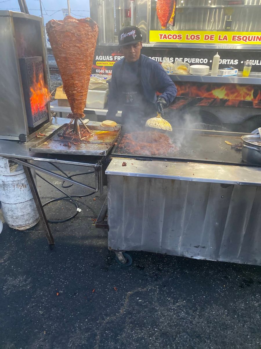 Al pastor being carved at the trompo